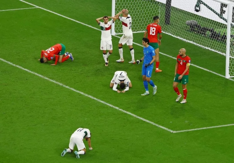 Portugal&#039;s Cristiano Ronaldo and Morocco&#039;s Yassine Bounou react.