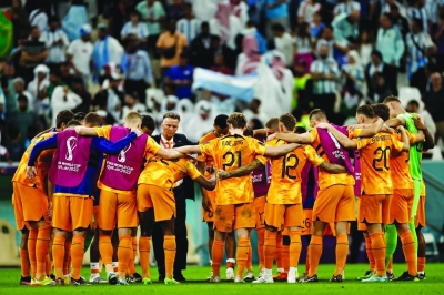 Netherlands coach Louis van Gaal with his players after their loss to Argentina in the quarter-finals of the FIFA World Cup at the Lusail Stadium on Friday. (Reuters)