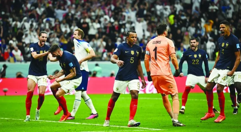 England’s Harry Kane looks dejected after missing from the penalty spot as France players celebrate yesterday. (Reuters)