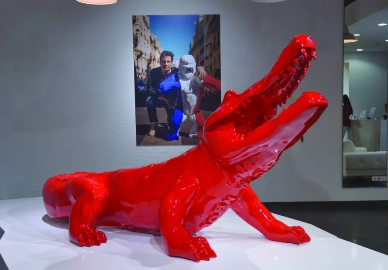One of the artist&#039;s works includes a bright red crocodile made of resin.