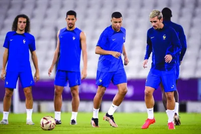 From left: France’s midfielder Matteo Guendouzi, defender William Saliba, forward Kylian Mbappe and forward Antoine Griezmann take part in a training session at the Al Sadd SC in Doha yesterday. (AFP)