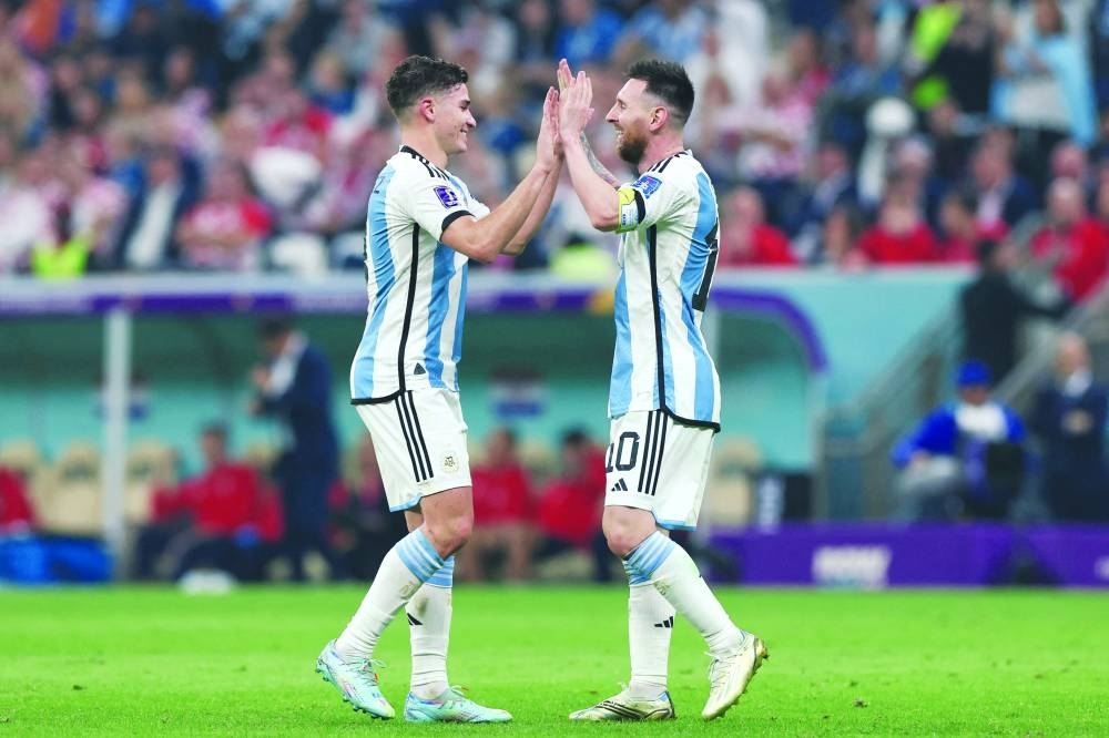 Argentina&#039;s forward #09 Julian Alvarez (left) celebrates scoring his team&#039;s third goal with Argentina&#039;s forward Lionel Messi during the Qatar 2022 World Cup semi-final against Croatia at Lusail Stadium in Lusail on Tuesday. (AFP)
