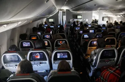 Passengers watch inflight entertainment while sitting in economy class during an American Airlines Group Boeing 777-200 flight from Los Angeles International Airport. With passengers returning to the skies in growing numbers as governments ease Covid-19 related restrictions, it is essential that travellers understand the unacceptability and possible legal consequences of unruly or disruptive behaviour in aviation facilities and onboard aircraft. 
