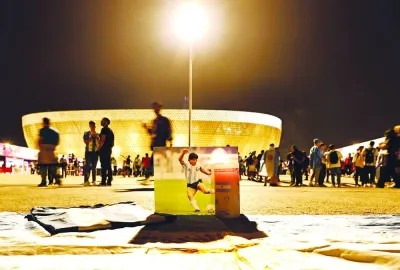 A picture of Diego Maradona, the former World Cup winner for Argentina, is displayed outside the Lusail Stadium on Tuesday. (Reuters)