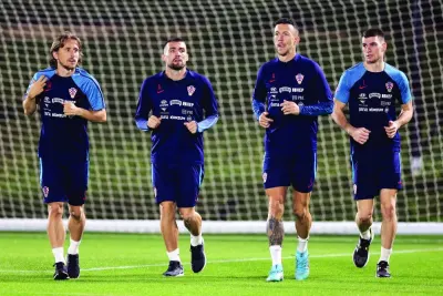 (From left) Croatia’s midfielders Luka Modric, Mateo Kovacic, Ivan Perisic and goalkeeper Dominik Livakovic take part in a training session at Al Erssal training site in Doha, yesterday. (AFP)