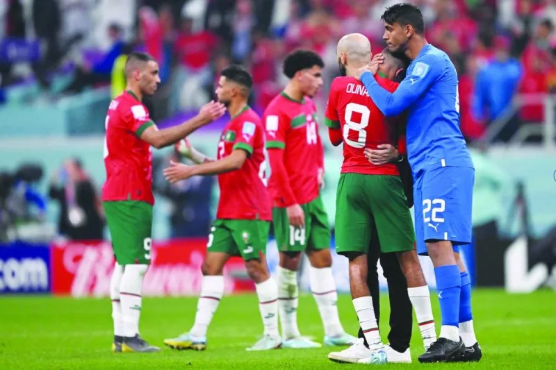 Morocco’s goalkeeper Ahmed Reda Tagnaouti comforts midfielder Azzedine Ounahi at the end of the semi-final against France yesterday. (AFP)