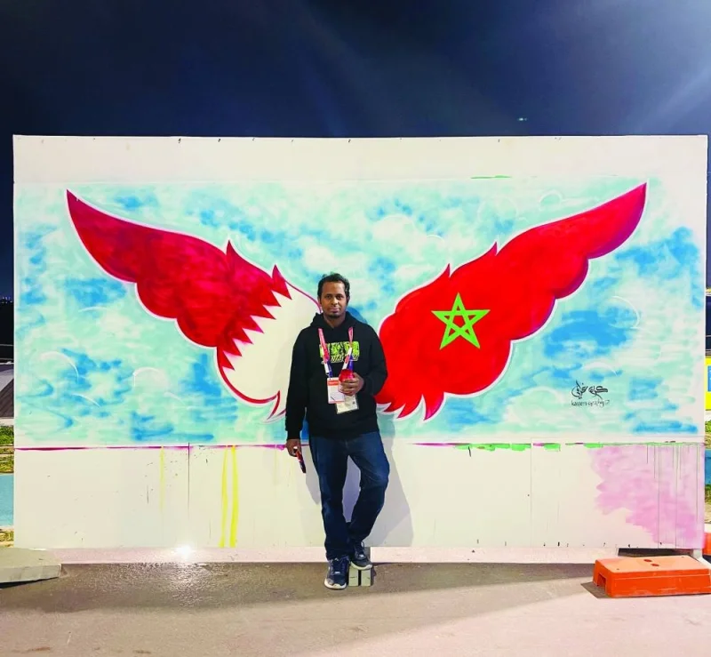 Indian calligrapher and painter Abdul Kareem Kakkove in front of one of his World Cup related artworks (supplied pictures).
