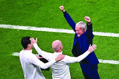     France’s coach Didier Deschamps (right) celebrates with assistant coach Guy Stephan (centre) and goalkeeping coach Franck Raviot after victory over Morocco. (AFP)


