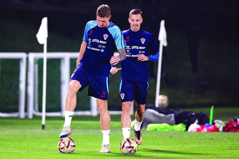 Croatia's midfielder #26 Kristijan Jakic (left) and forward Mislav Orsic take part in a training session at Al Erssal Training Site 3 in Doha yesterday. (AFP)
