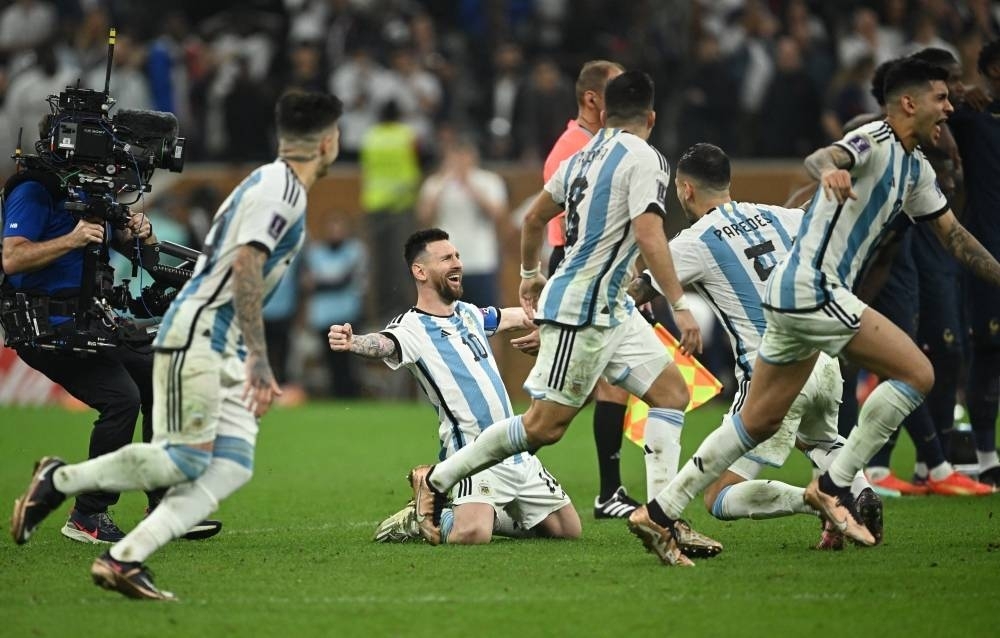 Argentina&#039;s Lionel Messi celebrates with Leandro Paredes after winning the World Cup. REUTERS