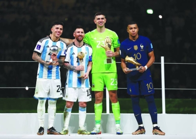 From left: Argentina’s Enzo Fernandez, Argentina’s Lionel Messi, Argentina’s Emiliano Martinez and France’s Kylian Mbappe pose after being awarded the Best Young Player, Golden Ball, Golden Glove and Golden Boot, respectively. (Reuters)