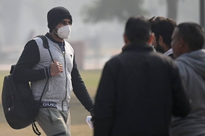 A man wears a mask as a precaution against the Covid-19 coronavirus while he walks near India Gate in New Delhi on December 23. AFP