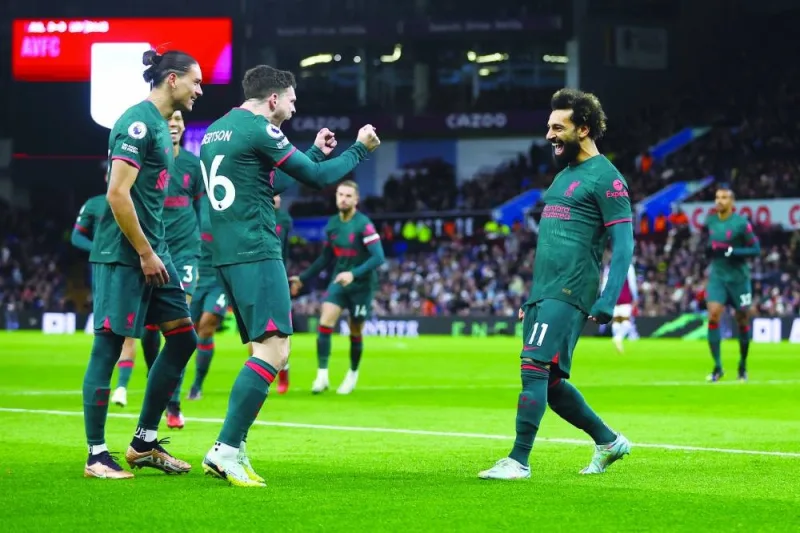 Liverpool’s Mohamed Salah (right) celebrates with teammates after scoring his team’s first goal during the English Premier League match against Aston Villa in Birmingham yesterday. (Reuters)