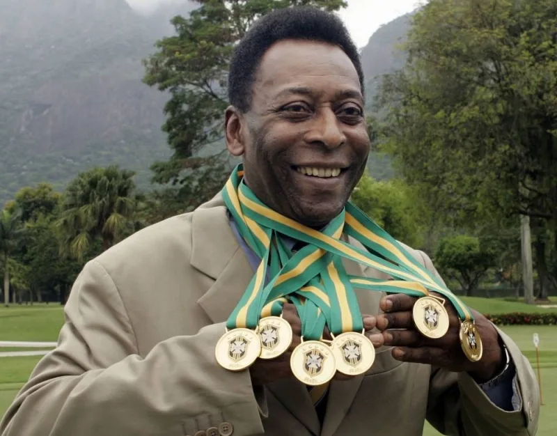 Pele poses with his six Brazil&#039;s champion medals during a ceremony in Rio de Janeiro, Brazil on December 22, 2010. AFP
