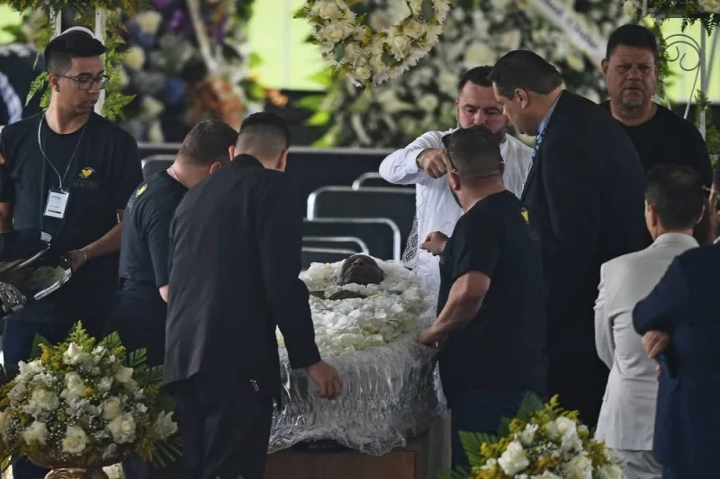 People prepare the coffin of Brazilian football legend Pele before his wake at the Urbano Caldeira stadium in Santos, Sao Paulo, Brazil. AFP