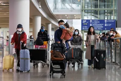 Passengers push their luggage through the international arrivals hall at Beijing Capital International Airport after China lifted the coronavirus disease (Covid-19) quarantine requirement for inbound travellers, yesterday.
