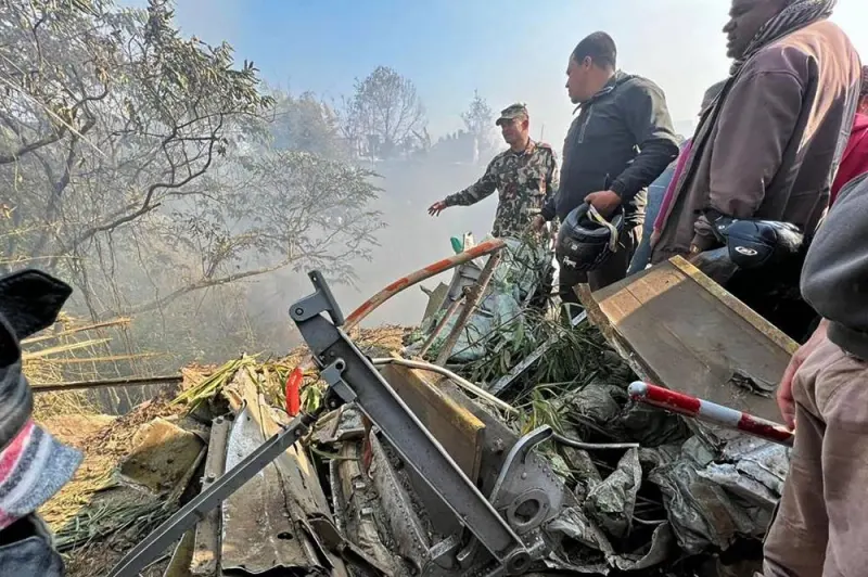 Rescuers gather at the site of a plane crash in Pokhara on January 15, 2023. - An aircraft with 72 people on board crashed in Nepal on January 15, Yeti Airlines and a local official said. (Photo by AFP)