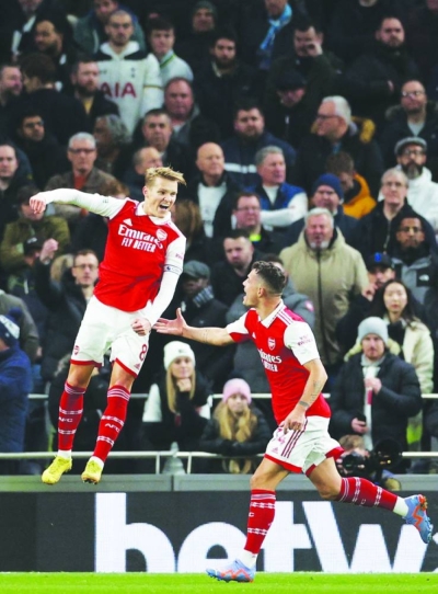 Arsenal’s midfielder Martin Odegaard (left) celebrates scoring a goal against Tottenham Hotspur in London yesterday. (AFP)