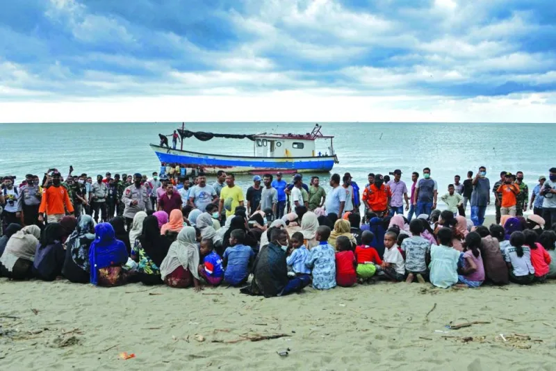 In a file picture, evacuated Rohingya from Myanmar sit on the shorelines of Lancok village, in Indonesia’s North Aceh Regency, after some 100 including 30 children were rescued from a wooden boat off the coast of Indonesian island of Sumatra.