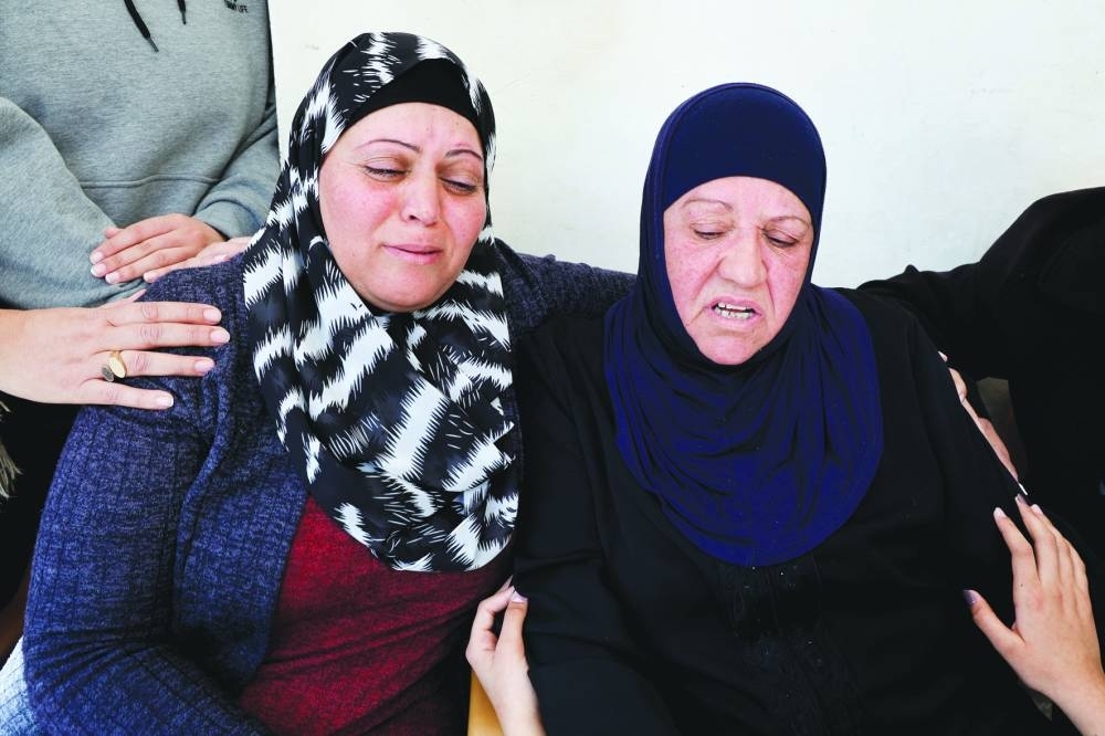 Family members of a Palestinian man, who was killed by Israeli forces, react, near Ramallah, in the occupied West Bank, yesterday.