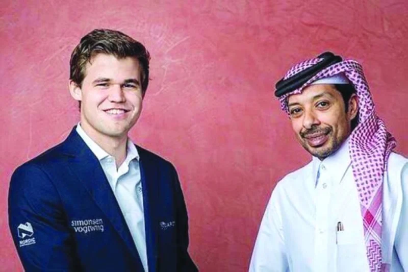 Qatar Chess Federation president Mohamed al-Mudahka (right) with world champion Magnus Carlsen.