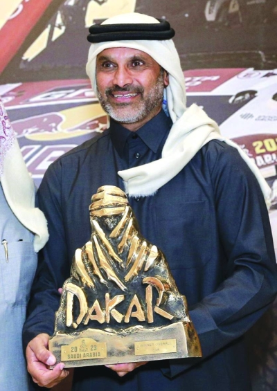 Nasser Saleh al-Attiyah poses with the Dakar Rally trophy during a felicitation function in Lusail.