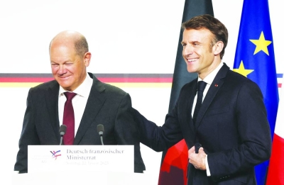 French President Emmanuel Macron and German Chancellor Olaf Scholz leave after a news conference following a Franco-German joint cabinet meeting as part of the celebration of the 60th anniversary of the signing of the Elysee Treaty, at the presidential Elysee Palace in Paris yesterday. (AFP)