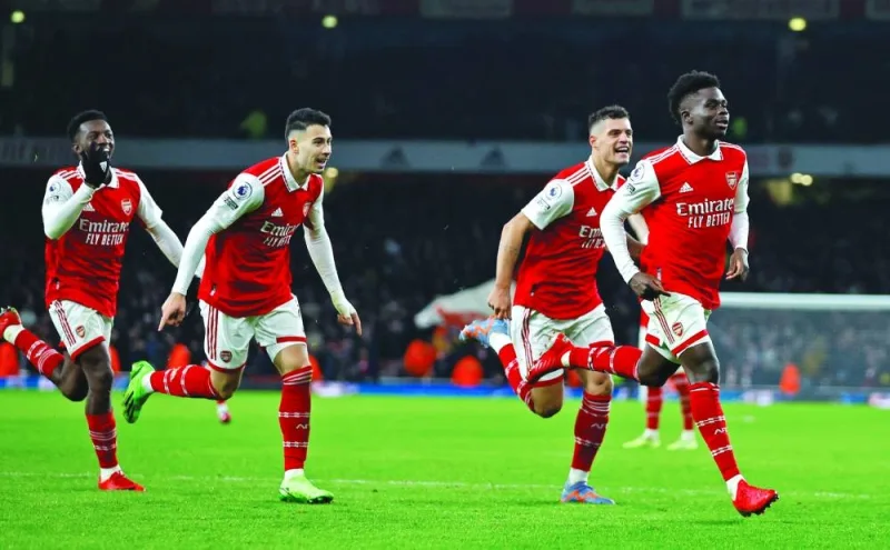 Arsenal’s Bukayo Saka (right) celebrates with teammates after scoring against Manchester United during the Premier League match in London on Sunday. (AFO)
