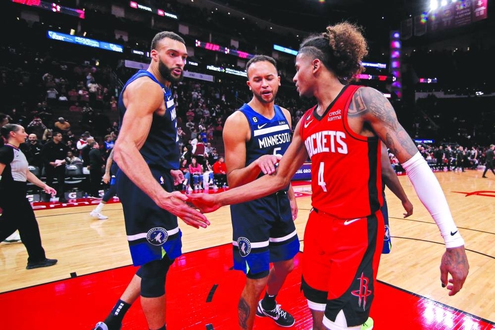 Houston Rockets guard Jalen Green (right) is greeted by Minnesota Timberwolves center Rudy Gobert (left) and forward Kyle Anderson following the game at Toyota Center. (USA TODAY Sports)