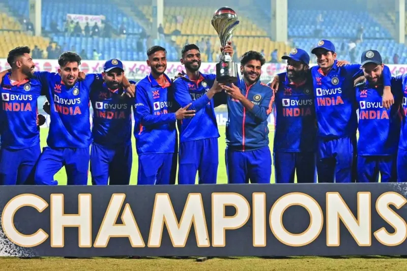 India’s players pose with the trophy after winning the third and final one-day international against New Zealand at the Holkar Cricket Stadium in Indore yesterday. (AFP) 