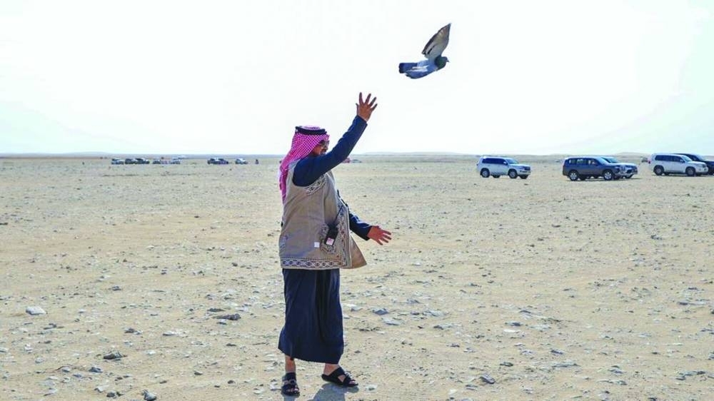 Prof Dr al-Sulaiti releasing a homing pigeon at the festival Tuesday.