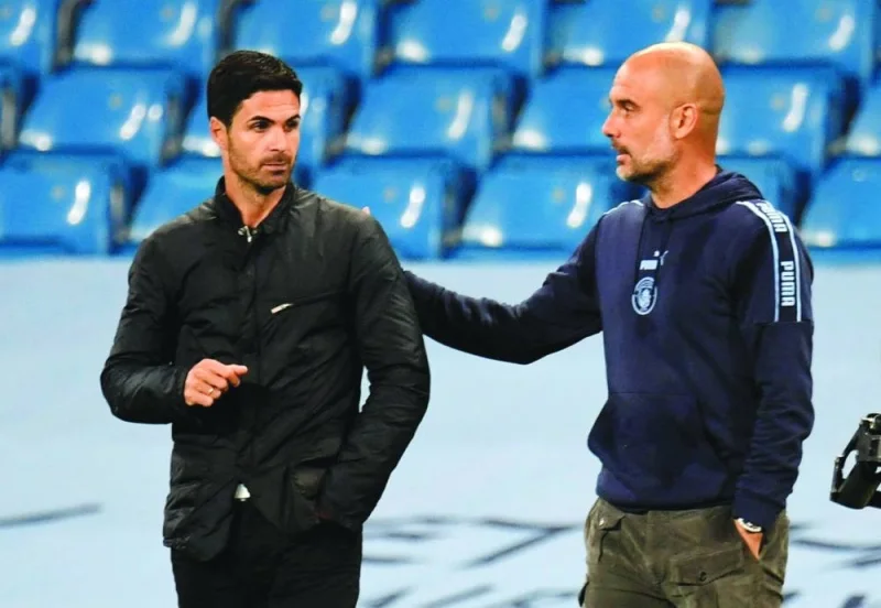 FILE PHOTO: Soccer Football - Premier League - Manchester City v Arsenal - Etihad Stadium, Manchester, Britain - June 17, 2020  Manchester City manager Pep Guardiola and Arsenal manager Mikel Arteta after the match as play resumes behind closed doors following the outbreak of the coronavirus disease (COVID-19) Peter Powell/Pool via REUTERS  EDITORIAL USE ONLY. No use with unauthorized audio, video, data, fixture lists, club/league logos or "live" services. Online in-match use limited to 75 images, no video emulation. No use in betting, games or single club/league/player publications.  Please contact your account representative for further details./File Photo