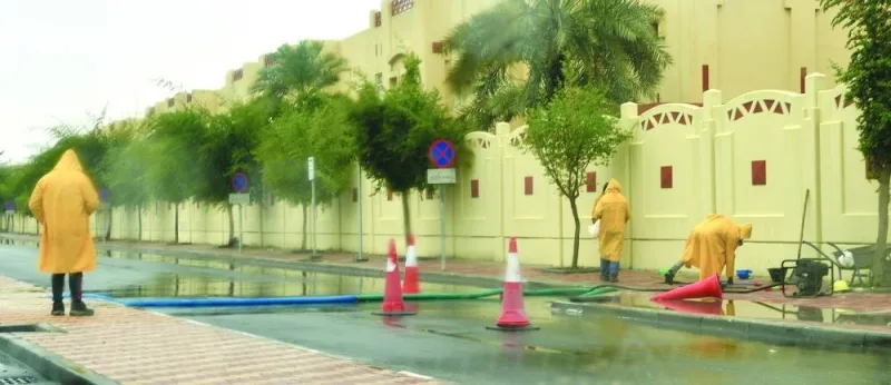 Municipal workers engaged in pumping out rain water from a location in Doha Friday. PICTURE: Shaji Kayamkulam