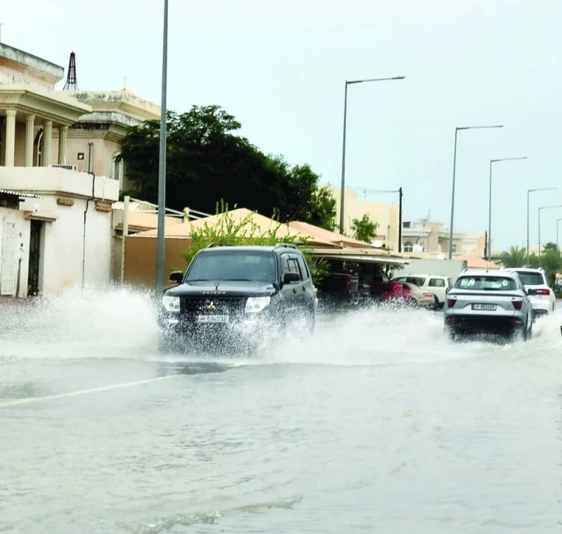 Vehicles passing through a flooded street in Doha. PICTURE: Shaji Kayamkulam