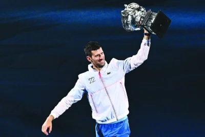 Serbia’s Novak Djokovic holds the Norman Brookes Challenge Cup after his victory against Greece’s Stefanos Tsitsipas in the final of the Australian Open in Melbourne yesterday. (AFP)