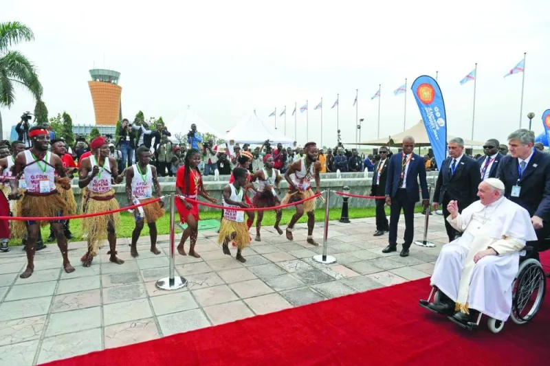 Pope Francis is greeted by dancers upon his arrival in Kinshasa.