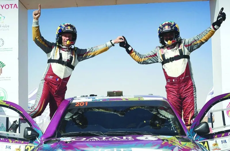 Qatar’s Nasser Saleh al-Attiyah (right) and French co-driver Mathieu Baumel celebrate after winning the Saudi Baja-Hail on Saturday. 