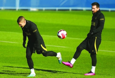 PSG’s Marco Verratti and Lionel Messi (right) take part in a training session in Paris yesterday. (AFP)