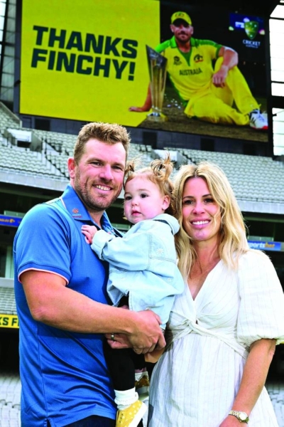 Australia’s Aaron Finch poses for photos with his wife Amy and daughter Esther after announcing his retirement from international cricket at the Melbourne Cricket Ground yesterday. (AFP)  