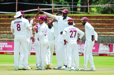 West Indies players celebrate the dismissal of a Zimbabwe batsman on day one of the second Test in Bulawayo yesterday.