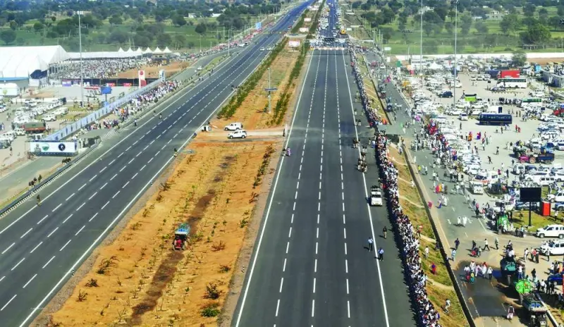 People standing along the newly-inaugurated Delhi-Dausa-Lalsot section of the Delhi-Mumbai Expressway in Dausa, in India's desert state of Rajasthan.