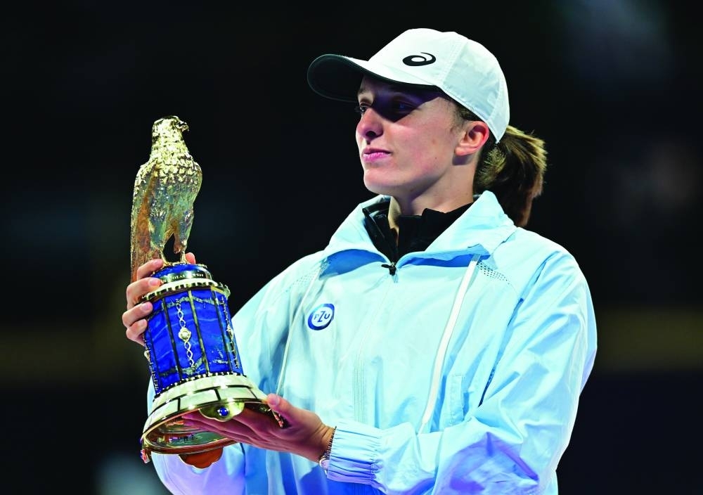 Iga Swiatek of Poland poses with the Falcon Trophy after winning the Qatar TotalEnergies Open final at the Khalifa Tennis and Squash Complex in Doha on Saturday. PICTURE: Noushad Thekkayil