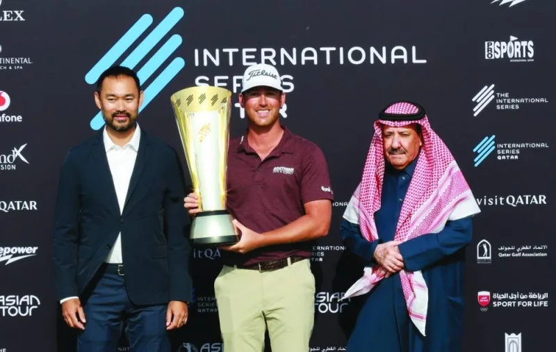 International Series Qatar winner Andrew Ogletree (centre) celebrates with the trophy along with Qatar Golf Association (QGA) President Hassan Nasser al-Naimi and Asian Tour CEO Cho Minn Thant during the presentation ceremony at the Doha Golf Club yesterday.