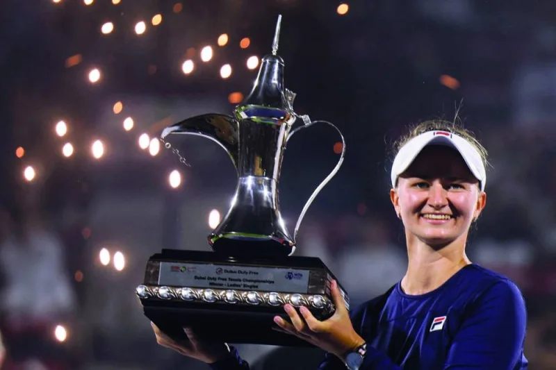 Barbora Krejcikova of the Czech Republic lifts the trophy of the WTA Dubai Duty Free Tennis Championship after defeating Iga Swiatek of Poland in the final match in Dubai yesterday. (AFP)