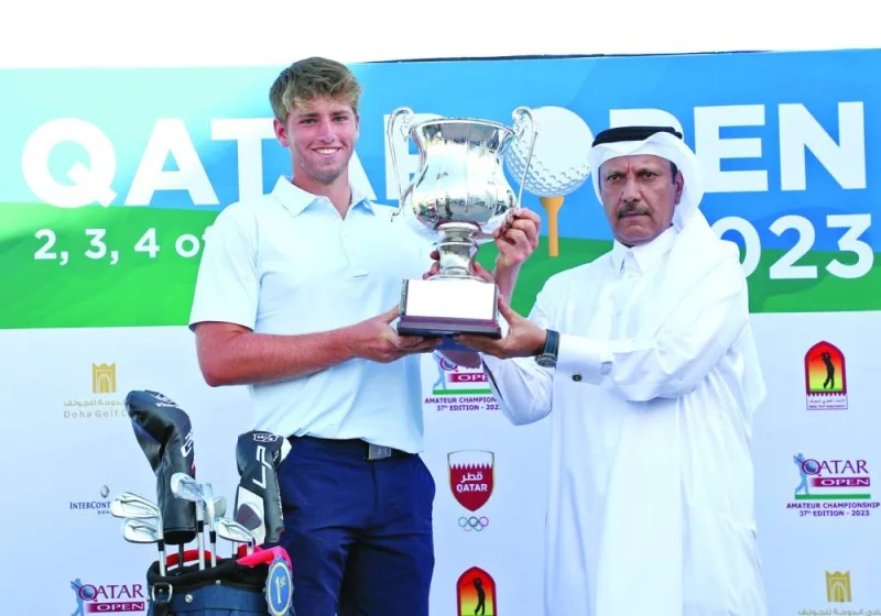 Qatar Golf Association (QGA) Deputy General-Secretary Eng. Mohamed Ibrahim al-Muhannadi presents the trophy to Qatar Open Golf Amateur Championship winner Joe Jones at the Doha Golf Club.