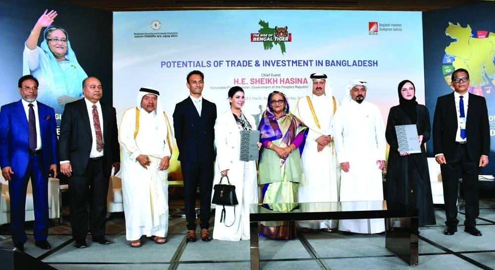 Bangladesh&#039;s Prime Minister, Sheikh Hasina Wazed, is joined on stage by Sultan bin Rashid al-Khater, Undersecretary of the Ministry of Commerce and Industry; QBA Chairman HE Sheikh Faisal bin Qassim al-Thani; QFC CEO Yousuf Mohamed al-Jaida; QFC Deputy CEO Sheikha Alanoud bint Hamad al-Thani; Ayestra Aziz Khan, managing director & CEO, Summit Power International; and other dignitaries during the Bangladesh Investment Summit held in Doha Monday. PICTURE: Thajudheen 