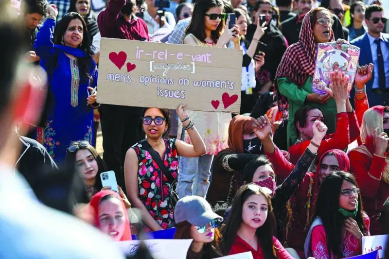 Activists of Aurat March hold placards as they chant slogans during a rally to mark the International Women’s Day in Islamabad on Wednesday. (AFP)