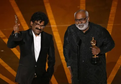 TOPSHOT - Indian composer M.M. Keeravaani (R) and Indian musician Chandrabose accept the Oscar for Best Music (Original Song) for "Naatu Naatu" from "RRR" onstage during the 95th Annual Academy Awards at the Dolby Theatre in Hollywood, California on March 12, 2023. (AFP)