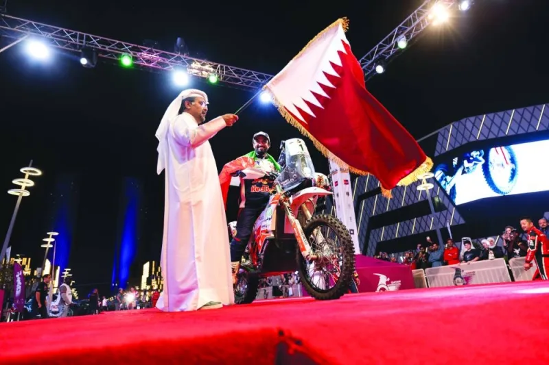 UAE’s Mohamed al-Balooshi is flagged off by the QMMF president Abdulrahman al-Mannai. 