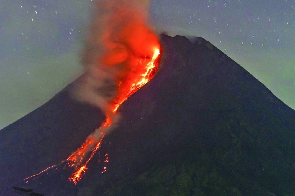Mount Merapi volcano spews lava from its crater as seen from Sleman in Yogyakarta early yesterday.
